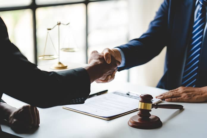 Portrait of lawyers agreeing holding hands in lawyer office giving advice and advice on case consult Free Probate Lawyer Advice